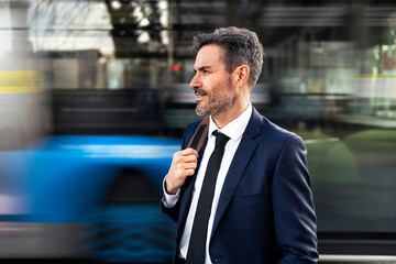 Well dressed businessman standing in city