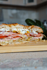homemade sandwich with salami, ham, tomatoes and cheese