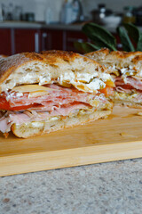 homemade sandwich with salami, ham, tomatoes and cheese