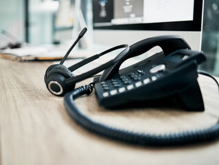 Telephone, contact us with call center, communication and headphone with microphone on work desk....