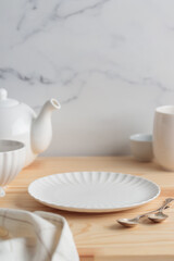 Empty tableware - white plate, a bowl and a cup on wooden table as a background for a dish foodbackground