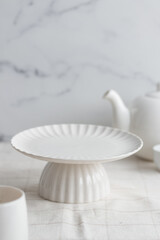 Fototapeta na wymiar Empty tableware - white cakestand on white background for a dessert
