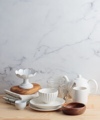 Empty tableware - white plate, a bowl and a cup on wooden table