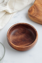 Empty tableware - wooden plate, a bowl and a cup on white table as a background for a dish foodbackground