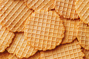 Healthy wafer snack. Thin salty and crunchy snacks. Waffle stacked. Party snack background. Dry round wafers texture.