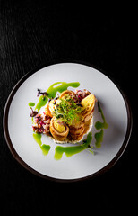 fried thin pancakes crepe stuffed potato with herring fish in plate