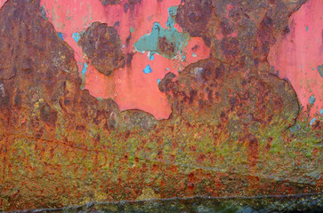 The surface of the iron is corroded by rust with traces of old paint.