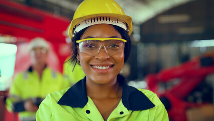 Portrait of woman looking camera at manufacturing special facility. Attractive women industrial...