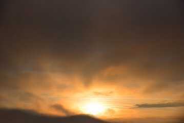 Fototapeta na wymiar dark sky background with sinking sun, yellow and gray color