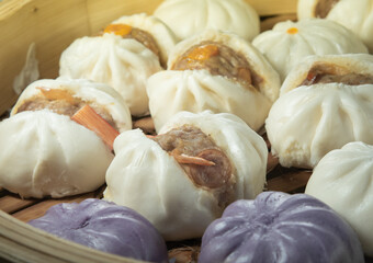 Bao or steamed buns stuffed with minced pork in a steamer basket, Chinese food. - 558669116