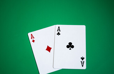 Pair of aces on green background.