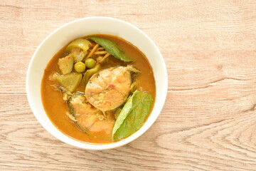 spicy boiled slice catfish with eggplant in coconut milk and curry on bowl