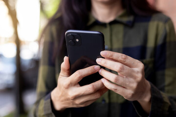 woman using cell phone hand holding mobile texting message contact us.chatting,search internet information.technology device communication connecting