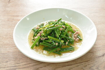 stir fried slice garlic chives with chop pork on plate