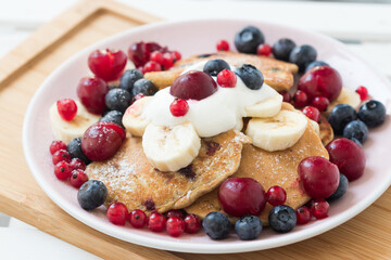 Stack of pancakes with fresh berries on top