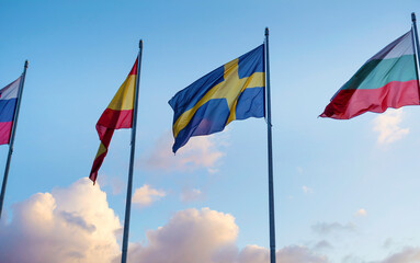 National flags in a row  against sunset blue sky with clouds	