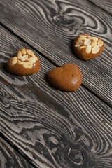 Homemade caramel. Brown caramel candies. Creamy sweets with peanuts. On pine boards.