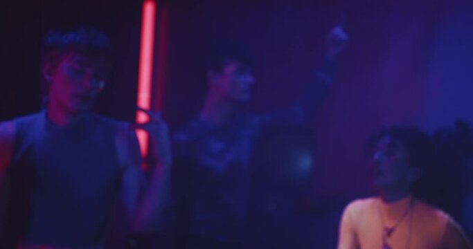 Group of young friends dancing at a neon party lgbt