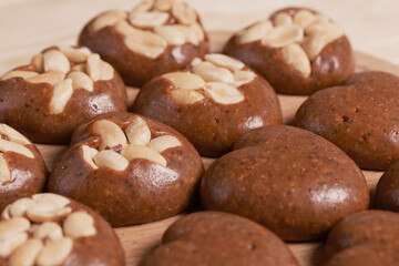 Homemade caramel. Brown caramel candies. Creamy sweets with peanuts. On pine boards.