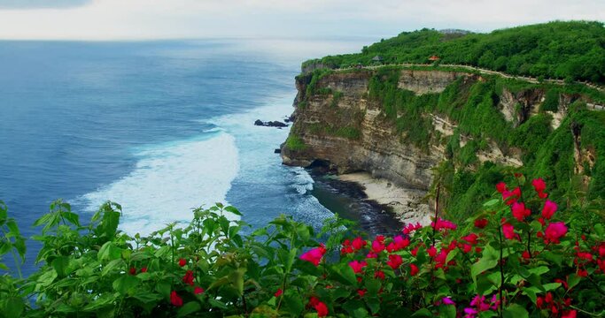Rocky coast ocean background. Travel to asian country Indonesia tropical Bali Island Uluwatu Temple Pura Luhur Hindu. Cinematic static view of wild world famous coastline. Outdoor adventure.