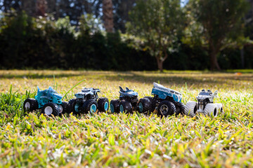 Boy is playing a cars multitrack on the garden 