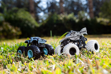 Boy is playing a cars multitrack on the garden 