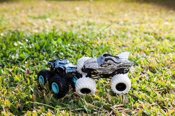 Boy is playing a cars multitrack on the garden 