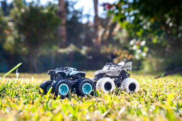 Boy is playing a cars multitrack on the garden 