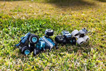 Boy is playing a cars multitrack on the garden 