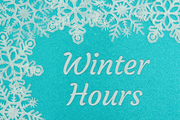 Winter Hours blue sign with white snowflakes