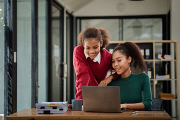 Two American women are working together in the office of a startup company. They are having a brainstorming and planning meeting in a joint department, women leading the way. Concept of women's work.