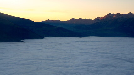 Sea of clouds over the mountains after sunset