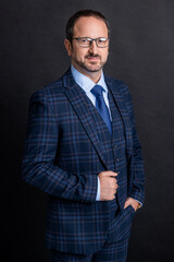 photo of executive in suit and glasses. mature executive isolated on grey studio background.