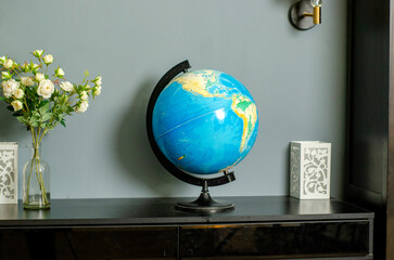 globe on the table in a modern style, on a gray background