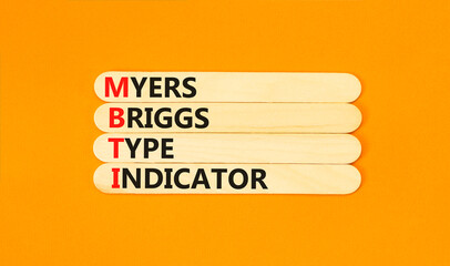 MBTI Myers Briggs type indicator symbol. Concept words MBTI Myers Briggs type indicator on stick on beautiful orange background. Psychological MBTI Myers Briggs type indicator concept. Copy space