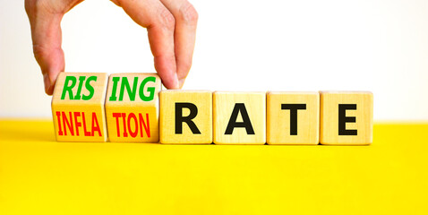 Inflation or rising rate symbol. Concept word Inflation rate Rising rate on wooden cubes. Businessman hand. Beautiful yellow table white background. Business inflation rising rate concept. Copy space.
