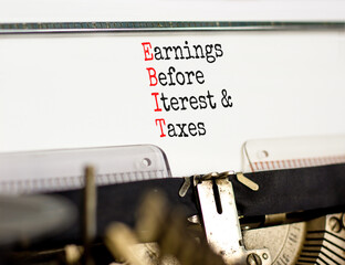 EBIT symbol. Concept words EBIT earnings before interest and taxes typed on retro typewriter on beautiful white background. Business EBIT earnings before interest and taxes concept. Copy space.