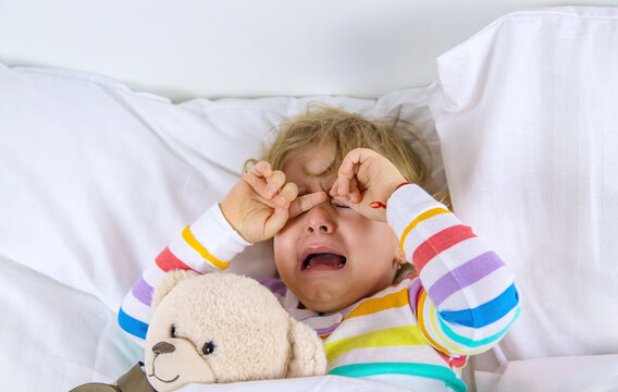 Children are crying in bed. Selective focus.