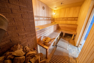 Fototapeta na wymiar wooden sauna interior wood-fired sauna with LED lighting 2021