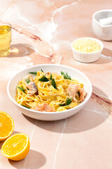 Pasta with salmon on a marble table