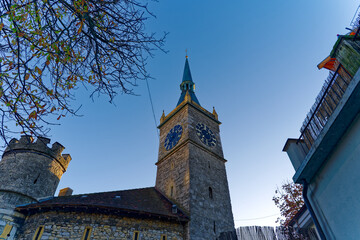 Stone clock tower at the old town at Swiss City of Biel Bienne on a sunny autumn day. Photo taken November 10th, 2022, Biel Bienne, Switzerland. - obrazy, fototapety, plakaty