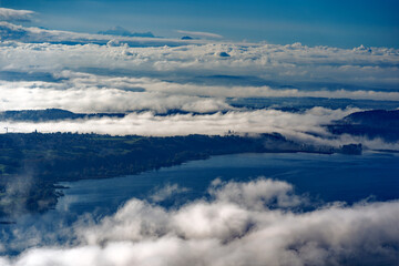 Aerial view from village Magglingen Macolin, Canton Bern, over City of Biel Bienne and lake with Aaare River on a blue cloudy autumn day. Photo taken November 10th, 2022, Magglingen, Switzerland.
