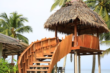 Wood Pavilion or straw hut near sand beach.