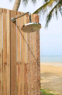 Outdoors shower while running water in the garden.