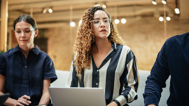 A Group of Multiethnic Enthusiastic Students Comparing Research Findings in University Study Room. Female Doctorate Researcher Joining her Colleagues to Analyze Study Results. Wide Shot