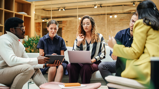 Diverse People In An Office Talking And Agreeing While Pointing At Tablet Screen. Multiethnic Startup Management Board Deciding On Changes For The Next Quarter. Close Up