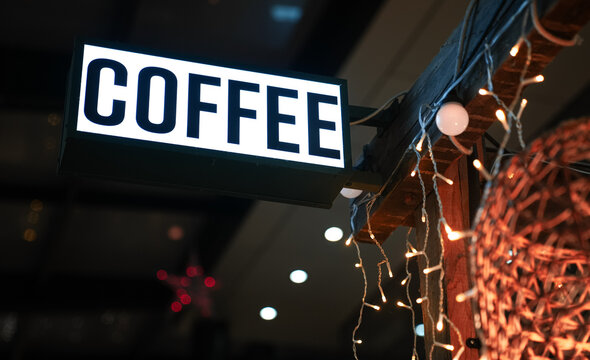 The logo sign of a coffee shop hanged on top of a terrace and coffee roasters market. Concept image for coffee industry.