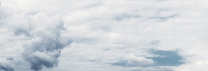 A whimsical cloud in the sky on a background of white clouds