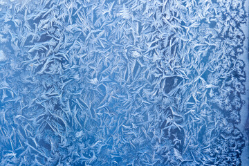 Frost patterns on window glass in winter