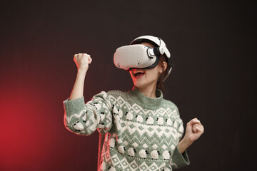 Asian woman wearing VR headset with neon light background to get exciting experience of virtual...